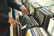 © New Africa - Man choosing vinyl records in store, closeup