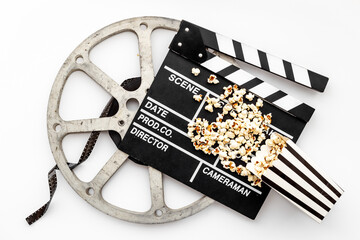 Movie film reel with clapperboard and popcorn. Cinema concept