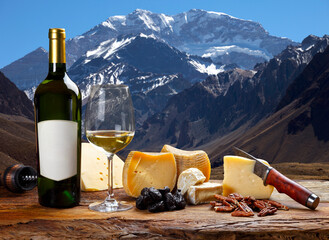 Wall Mural - White wine accompanied by various cheeses.