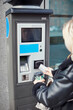 © Johnér - Woman using card to withdraw money from ATM