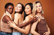 © iordani - young pretty caucasian, afro, asian, scandinavian woman posing cheerful together on brown background, lifestyle diverse nationality people concept