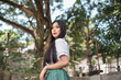 A pretty young popular Filipina student in senior high uniform outdoors.