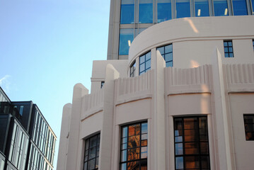 reflections in glass windows of art deco office building