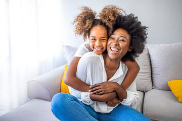 Wall Mural - Closeup photo of cute small girl young charming mommy hugging holding each other close piggyback sitting comfy sofa spend free time together home house indoors