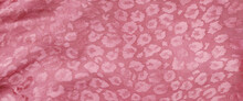 Pink Leopard Print Fabric Is Smooth With Folds 
