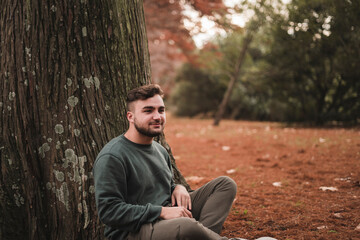 Portrait of a young Caucasian man in a park