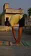 © vikash - young man doing yoga on the roof.