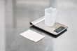 © Anischenko - A silver electronic scale sits on the kitchen table