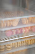 © Anischenko - Colorful macaroons in transparent boxes are stored in the refrigerator