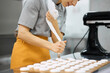 © Anischenko - Pastry chef girl prepares fresh cakes at her small production facility