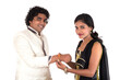 © Dip Photography - Indian young sister tying rakhi on brother's wrist, a tradition on Raksha Bandhan festival