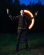 © ISliM - A guy in a Robin Hood costume stands in the background of a burning torch