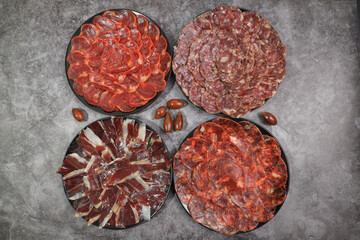 Wall Mural - Several servings of Iberian sausages: Iberian ham, loin, chorizo and 100% acorn-fed salchichón