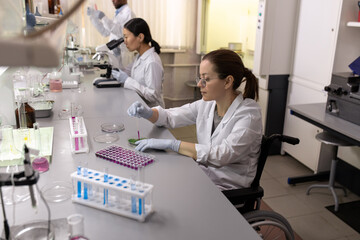 Sticker - Middle aged female scientist working with blood tests in flasks