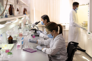 Sticker - Group of contemporary scientists in whitecoats working in lab