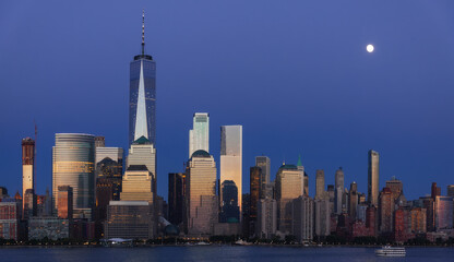 Fototapete - Full Moon Rising Over Lower Manhattan at Blue Hour