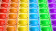 Rainbow pop it fidget toy as background, closeup. 3d render.