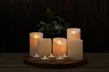 Poster - Beautiful decorative LED candles on wooden table