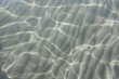 Clear shallow water with clean find sand on the floor.