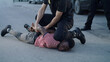 Policeman putting handcuffs on crying black man