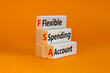 FSA flexible spending account symbol. Concept words FSA flexible spending account on wooden blocks on a beautiful orange background. Business and FSA flexible spending account concept.