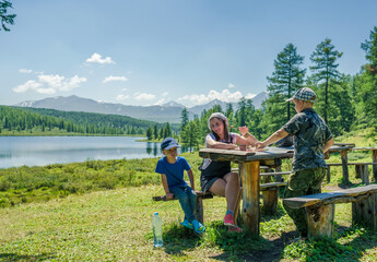 Mother and sons dinning in the mountains