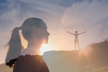 Wall Mural - Happiness and freedom. Happy strong young woman standing on top a mountain feeling free and looking to the future. 
