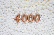 4000 followers card. Template for social networks, blogs. Background with white marshmallows. Social media celebration banner. 4k online community fans. Four thousand subscriber