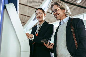 Wall Mural - Flight attendant assisting passenger at airport