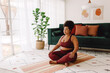 © (JLco) Julia Amaral - Plus size woman practicing meditation at home