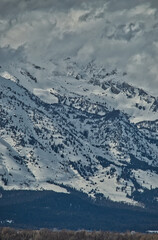 Sticker - Vertical shot of a majestic snowy mountain on background of the cloudy sky