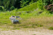 Several beehive boxes in grassy field in rural countryside.