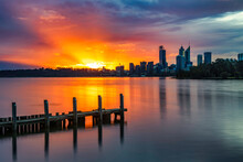Sunset With Sunrays At Swan River, With Jetty In Foreground, And Perth City In Background
