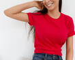 Tshirt mockup, front view of unrecognizable woman wearing red tshirt. Copy space on empty area on her t-shirt for design or inscription. Fashion lifestyle mock up of red tshirt. T-shirt template.