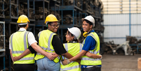 Unity and teamwork concept. team standing hands together. Professional Mechanical Engineer team Working at Second-hand spare parts of old car parts warehouse store.