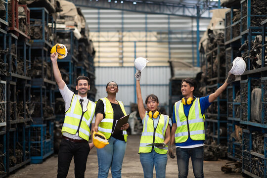 Unity and teamwork concept. team standing hands together. Professional Mechanical Engineer team Working at Second-hand spare parts of old car parts warehouse store. High five.