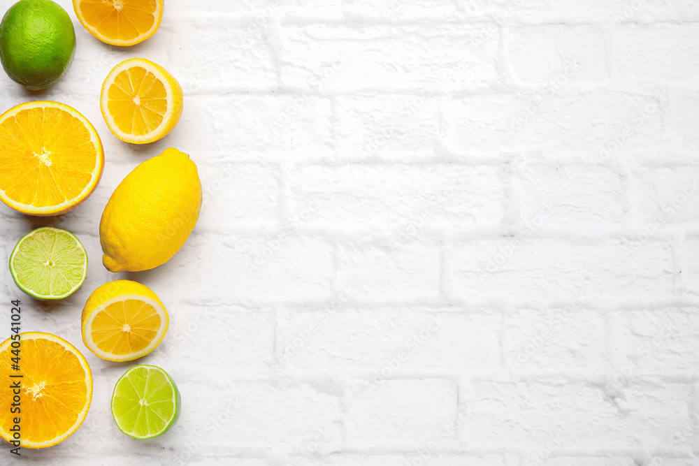 Healthy citrus fruits on brick background