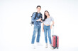© Thirawatana - Young tourists carrying suitcases and cameras. Young man carrying a travel backpack and ready to go to the travel with his girlfriend.