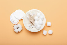Plate With Cotton Swabs, Balls And Pads On Color Background