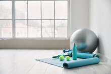 Set Of Sports Equipment With Fitness Ball In Gym