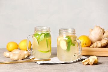 Mason jars of cold ginger lemonade on table