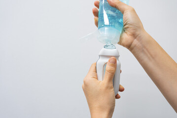 close up view of hand put ultrasound gel on cardiac probe on white background. medical equipment con