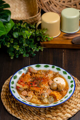 Wall Mural - Seblak is an Sundanese savoury and spicy dish, originating from the Sundanese region in West Java, Indonesia. Made of wet krupuk  cooked with  egg, chicken or beef, noodle and vegetables