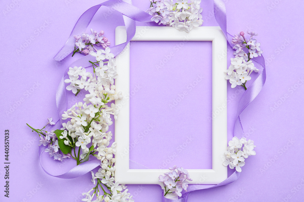 Beautiful lilac flowers and frame on color background