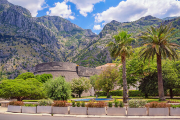 Wall Mural - Montenegro.  View of Old Town of Kotor.  Square with fountain. Walls of ancient fortifications and Kampana Tower