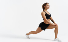 Beautiful Female Athlete Stretching Before Workout Indoors. Sport Woman Stretch Legs, Doing Gym Exercises Alone Isolated White Background, Silhouette Of Girl Warming Up