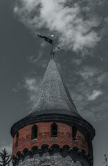 Wall Mural - large old castle tower. Against the background of a cloud