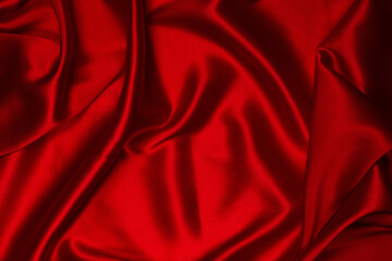 Rich and luxury red silk fabric texture background.