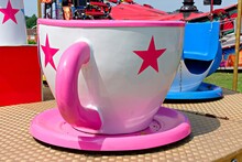Teacup Ride At Fair. Close Up Of Large Pink And White Teacup.