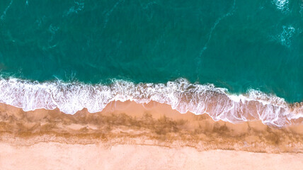  Aerial. Beautiful sea waves on a sandy beach. Top view from drone.